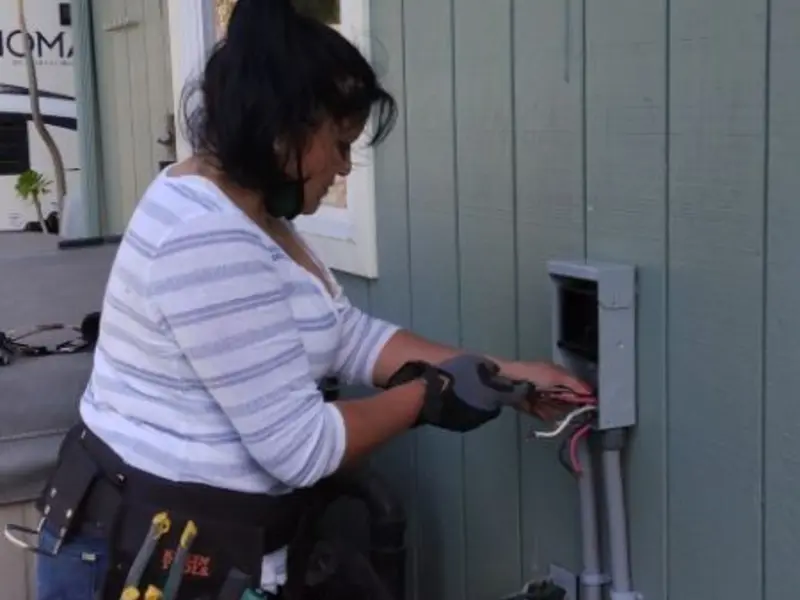 Licensed electrician wiring an exterior subpanel in Eaton